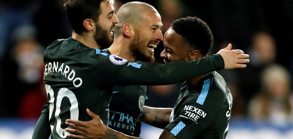 Manchester City's David Silva celebrates scoring their third goal with Raheem Sterling and...