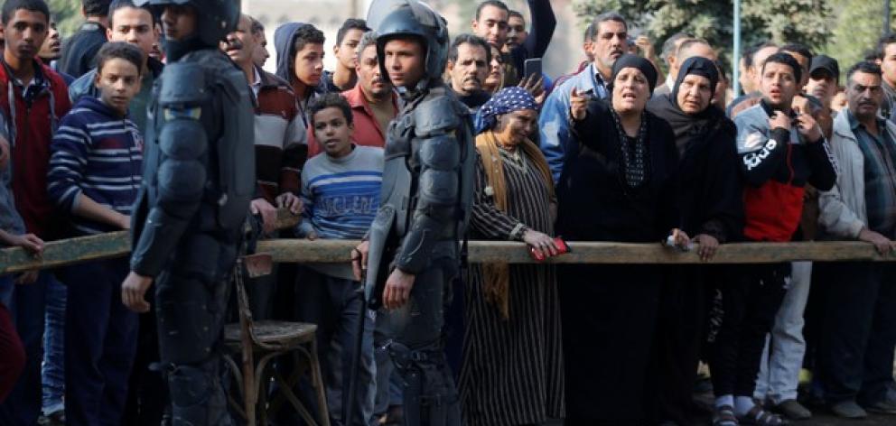 People gather at the site of attack on a church in the Helwan district south of Cairo. Photo: Reuters