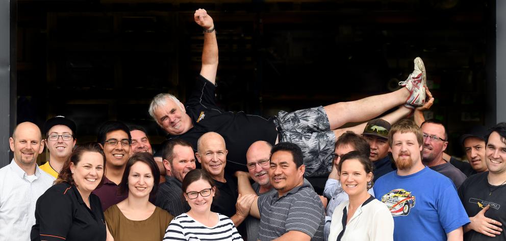 Bruce Boothby is held aloft by Escea colleagues (from left) Richard Swney, Ryan Savage, Emma Dennison, Diego Ramirez, Dave Olsen, Kasee Bellamy, Michael Gawthrop, Alana Taylor, Steve Joint, Brent Cayford, Toa Chadwick, Kelda Hunter, Neil King, Semisi Kioa
