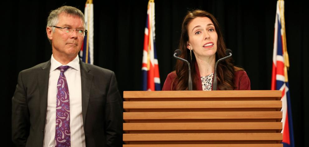 Prime Minister Jacinda Ardern speaks while Minister for Economic Development David Parker looks...
