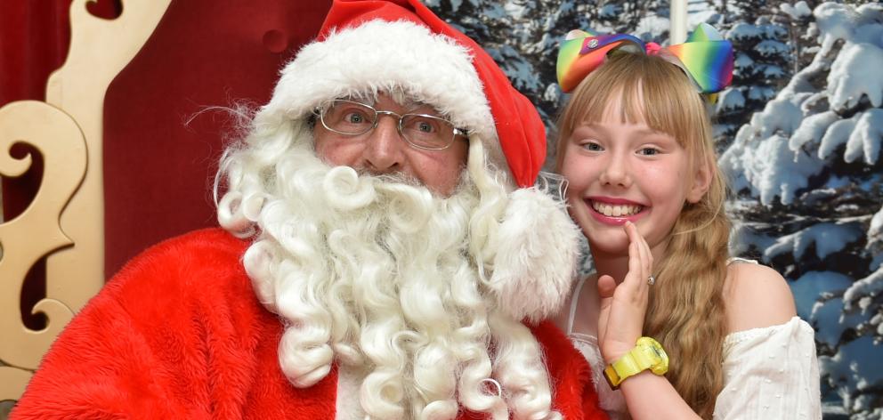 Alaya Cunningham (9) whispers her Christmas wishes to Santa in the  Meridian mall yesterday ...