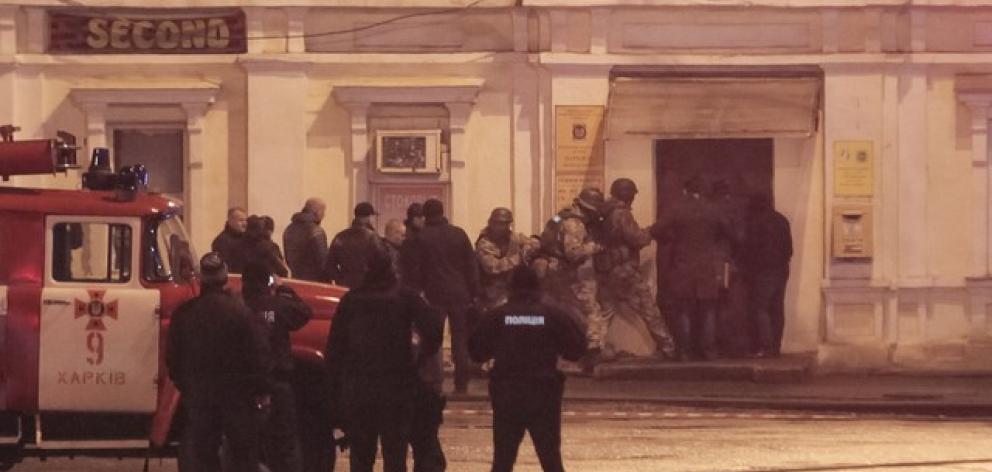 Members of a police special operations unit gather outside a post office, where a man took people hostage, in Kharkiv. Photo: Reuters