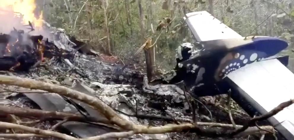 Wreckage in flames after a plane crashed in the mountainous area of Punta Islita, in the province...