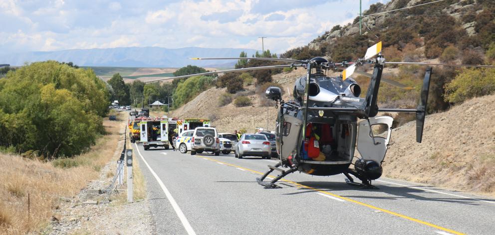 Fire crews clear up a scene where a car rolled near Bendigo yesterday, killing one person. Photos...