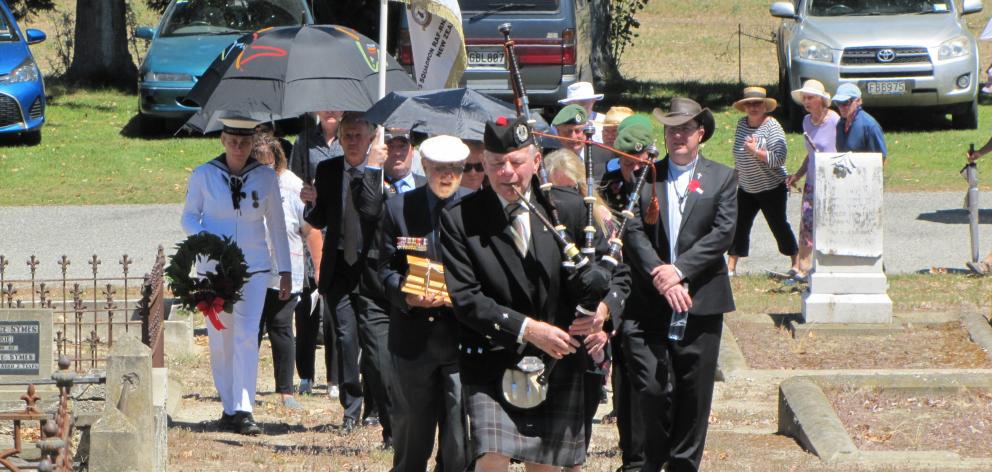 Piper  Alex Joyce, of Alexandra, leads in the group  to inter the ashes of Wing Commander Arthur ...