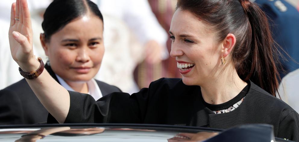 New Zealand's Prime Minister Jacinda Ardern waves to student dancers (not pictured) upon her...