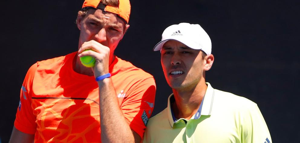 Jan-Lennard Struff of Germany (L) and Ben McLachlan of Japan talk tactics in their second round men's doubles match against Feliciano Lopez and Marc Lopez (both of Spain). Photo: Getty Images