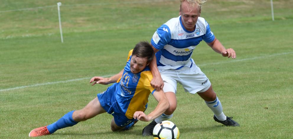 Southern United’s Tom Connor (left) and Tasman United’s Kieran Smith battle for possession in...