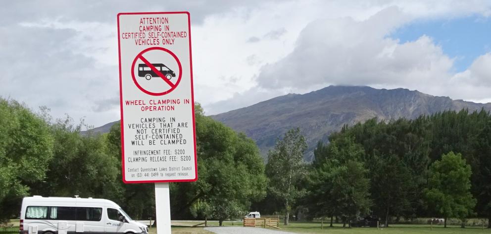 The Queenstown Lakes District Council posts stern warnings at popular camping areas, including...