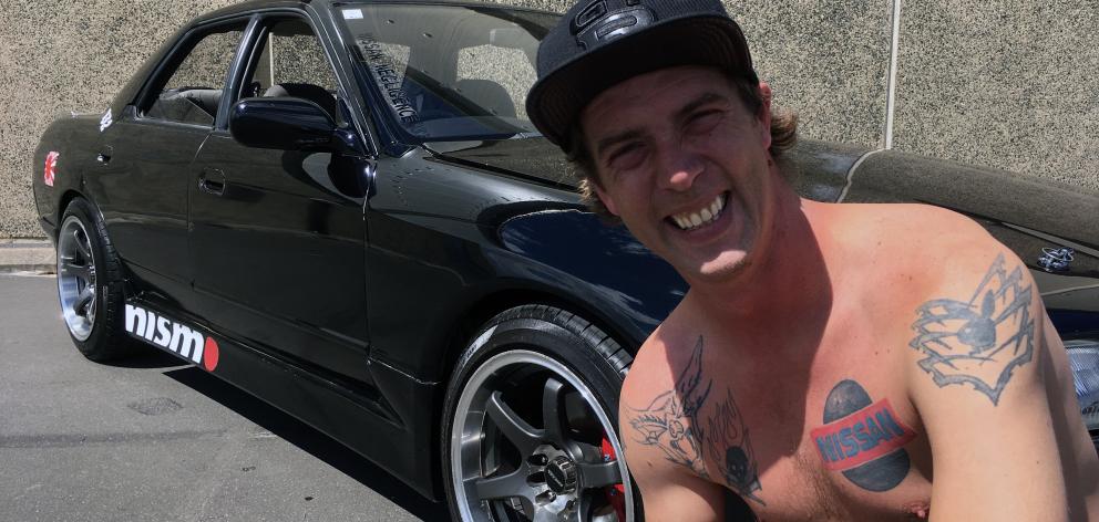 Southern Skyline Enthusiasts member Brendan Austin shows the tattoo on his chest of the Nissan logo and his 1989 Nissan Skyline in the car park near Dunedin Ice Stadium on Tuesday. Photos: Shawn McAvinue Southern Skyline Enthusiasts member Brendan Austin shows the tattoo on his chest of the Nissan logo and his 1989 Nissan Skyline in the car park near Dunedin Ice Stadium on Tuesday. Photos: Shawn McAvinue