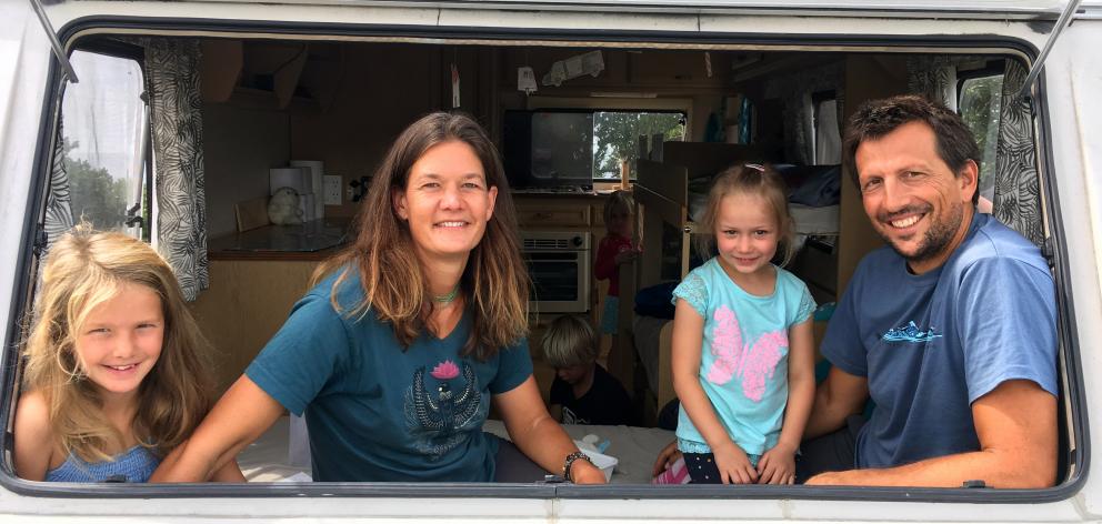 German freedom campers (from left) Antonia (8) and Anke Roser, Elisa Bauer (5) and Jochen Roser relax in a caravan at Brighton Domain last week. PHOTO: SHAWN MCAVINUE