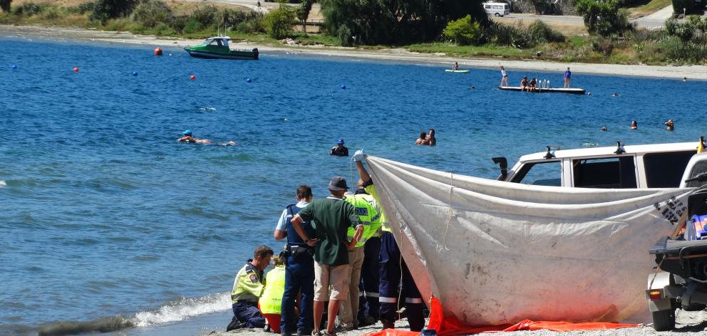 St John personnel and Wanaka volunteer firefighters try to revive a man at the water's edge of...