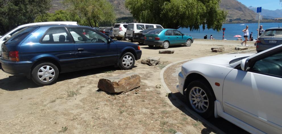 Cars park on grassy areas along Wanaka’s lakefront over the New Year period. Photo: Kerrie...