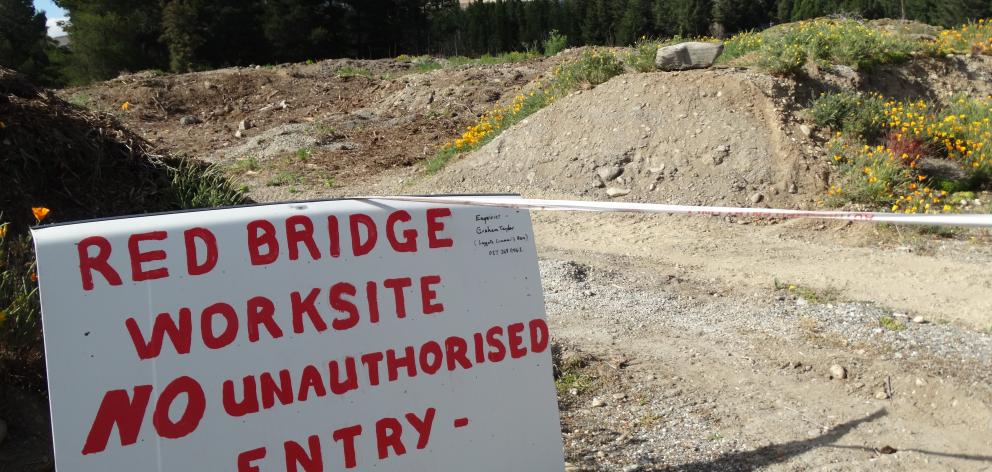 A sign and tape blocking access to the work site.