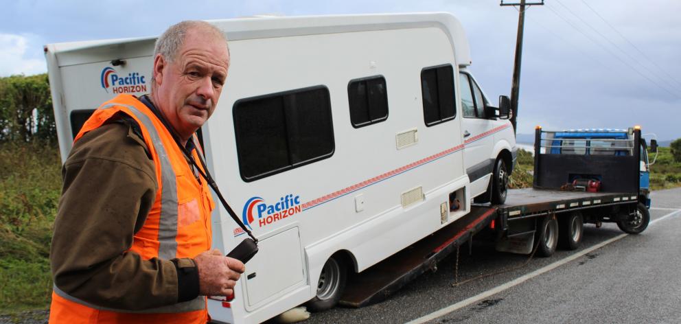 John Wentworth retrieves a campervan which was blown over on the Coast Road, at 17 Mile. Photo: Greymouth Star
