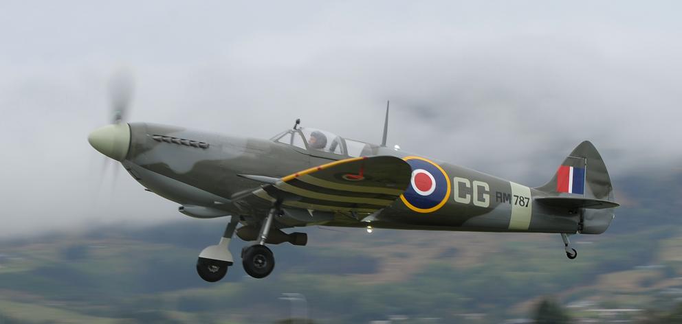 Ivan Campbell brings his replica Spitfire ‘‘Charlie Gold’’ in to land at the Taieri Wings and...