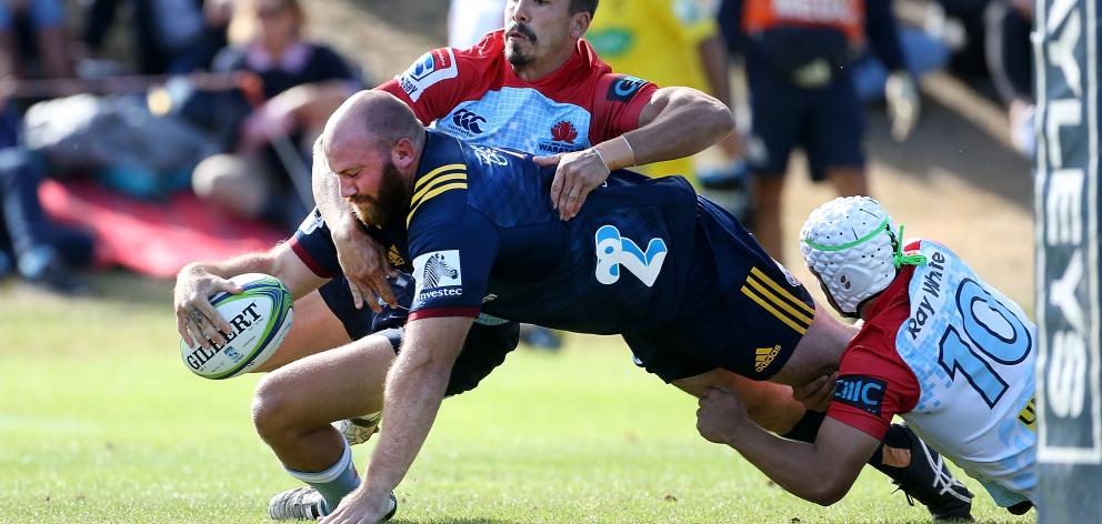 Greg Pleasants-Tate, of the Highlanders, in the clutches of  Jake Gordon, of the Waratahs,  dives...