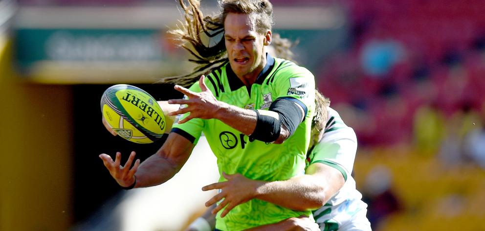 Highlanders loose forward Dan Pryor gets his pass away in the tackle during his side’s  Brisbane...