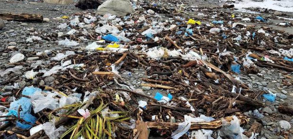 Tens of thousands of plastic bags covered Cobden Beach, Greymouth, after ex-Cyclone Fehi. Photo: Tony Kokshoorn