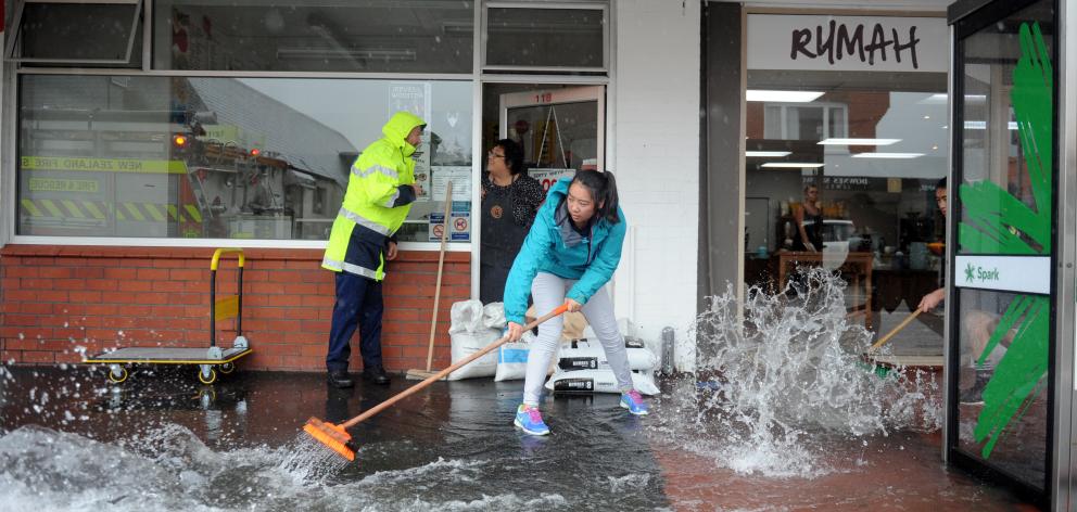 Kymberlee Choie (18) keeps the water out of the family’s fish and chip shop in Gordon Rd,...