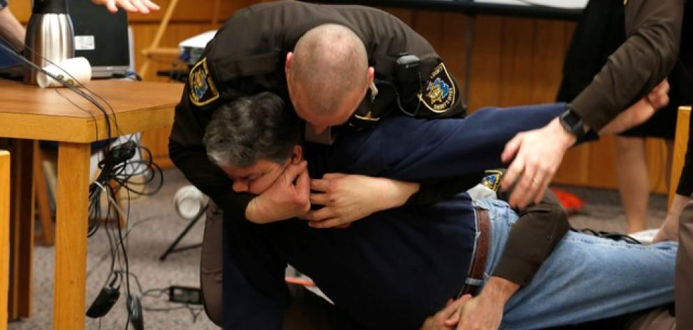 Eaton County Sheriffs restrain Randall Margraves after he lunged at Larry Nassar. Photo: Reuters