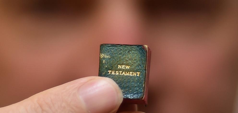 Dunedin librarian Julian Smith holds what could be the world’s smallest printed New Testament...