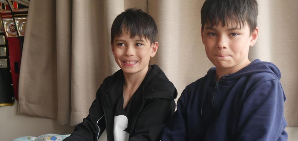 Levi (left) and Konrad Maaka play with their wrestling figurines at home last week. PHOTO: JESSICA WILSON