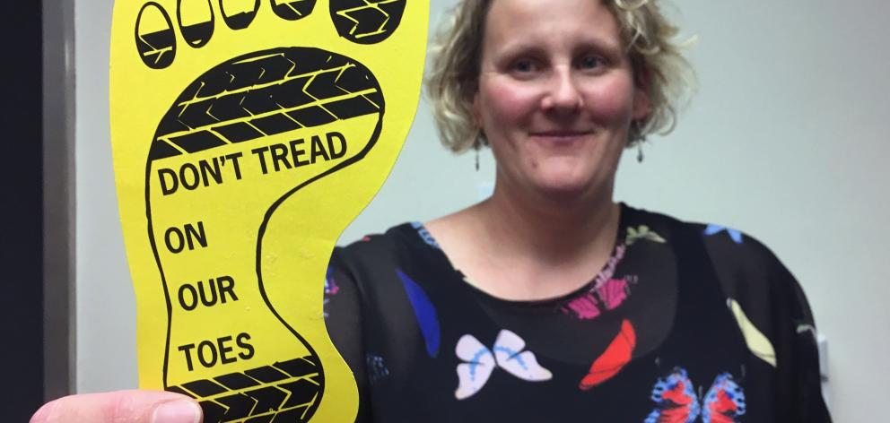 Saddle Hill Community Board deputy chairwoman Leanne Stenhouse holds a ‘‘yellow feet’’ card,...
