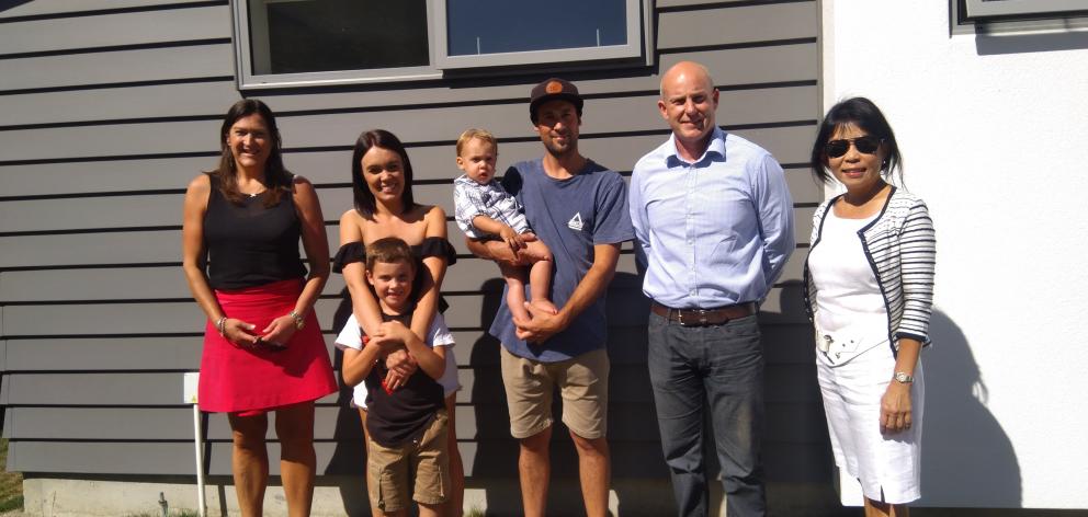 Outside one of the housing trust homes at Riverside are from (left) trust executive officer...