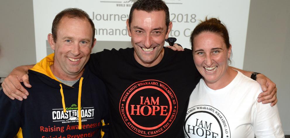 The Key to Life Trust ambassador Scott Weatherall (centre) embraces two of his Coast to Coast...