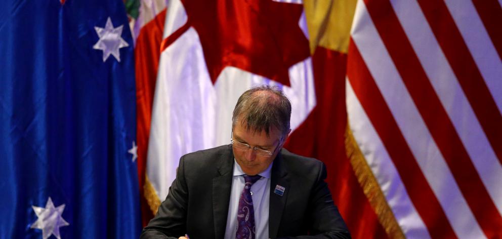 Trade and Export Growth Minister David Parker signing the CPTPP in Santiago yesterday. Photo:...