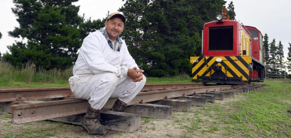 Beekeeper Blair Dale beside former New Zealand Railways Department shunting locomotive Ds201. Mr...