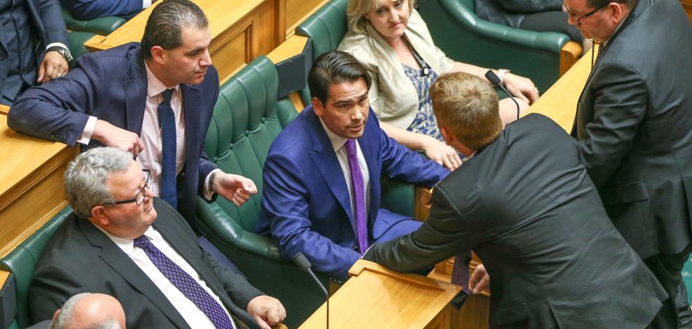Simon Bridges talking with other National MPs in Parliament. Photo: Getty Images