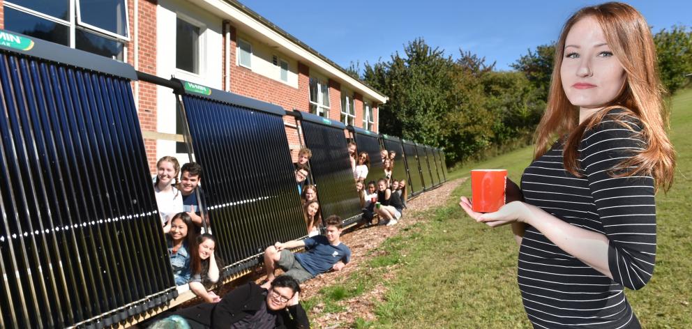 Aquinas College resident Alyssa Cruickshank enjoys the sun beside the solar fence at Aquinas,...