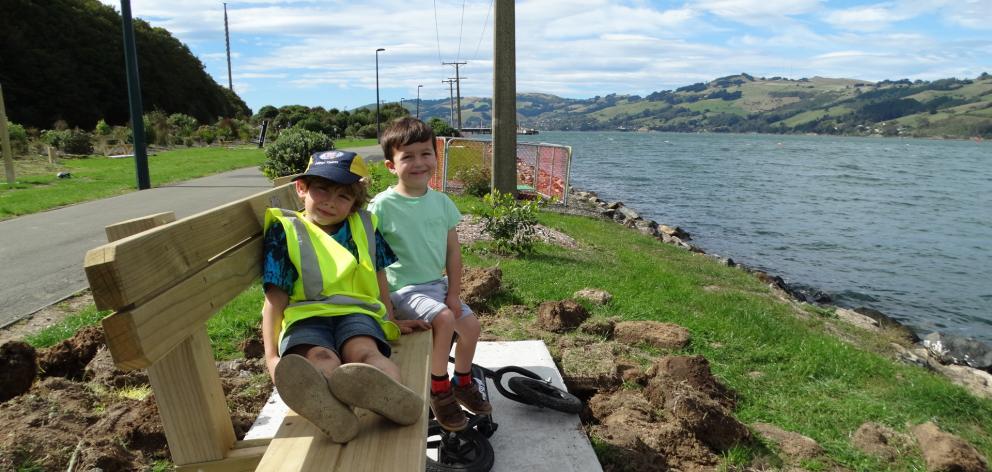 Dunedin youngsters Sarn Corson (5, left) and Toby Cooke (4) relax on a recently installed bench...