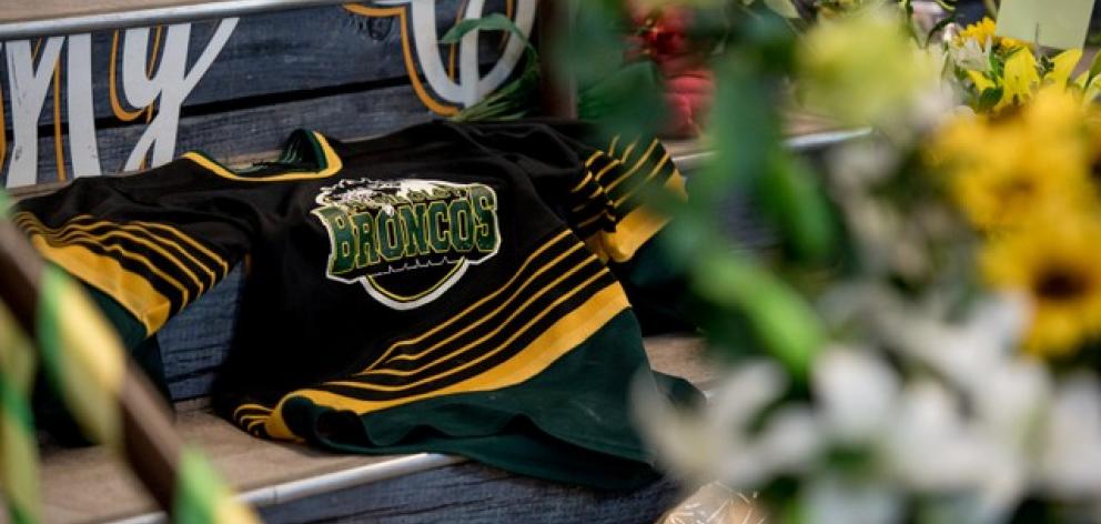 A Humboldt Broncos team jersey is seen among notes and flowers at a memorial for the Humboldt Broncos team. Photo: Reuters