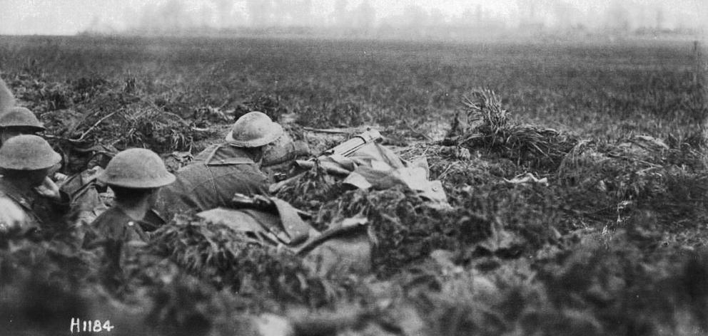 New Zealand troops lie in wait in a machine-gun post on the Somme during the Spring Offensive in...