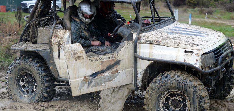 Muddy water flows out after driver Alistair Robbie, accompanied by co-driver Barry Dodd, opens...