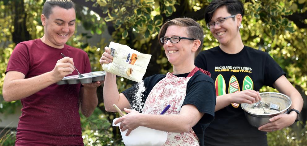 Otago University Students’ Association queer support co-ordinator Hahna Briggs (centre) gets...