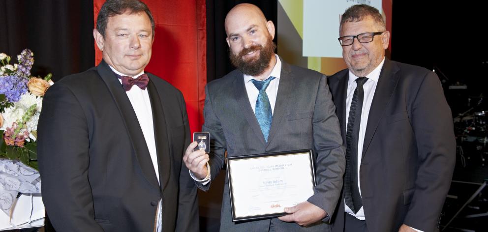 James Douglas Medallion winner Kelly Adam (centre), of Dunedin, Master Plumbers chairman Craig Foley (left) and Skills Organisation chief executive Garry Fissenden celebrate during the New Zealand Plumbing Awards in Hamilton on March 23. Photo: Supplied