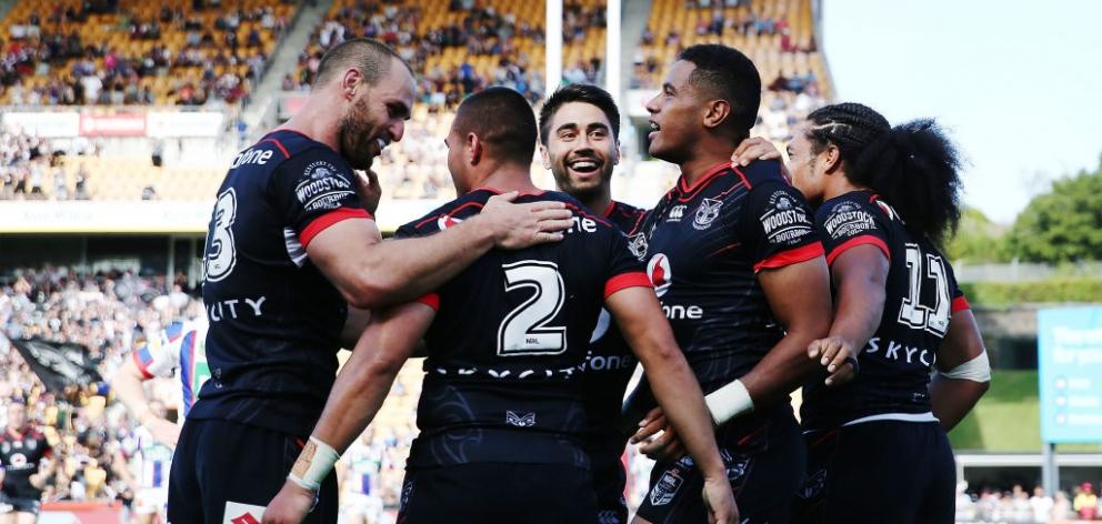 Warriors players celebrate a try during their first game of the season against Newcastle. Photo:...