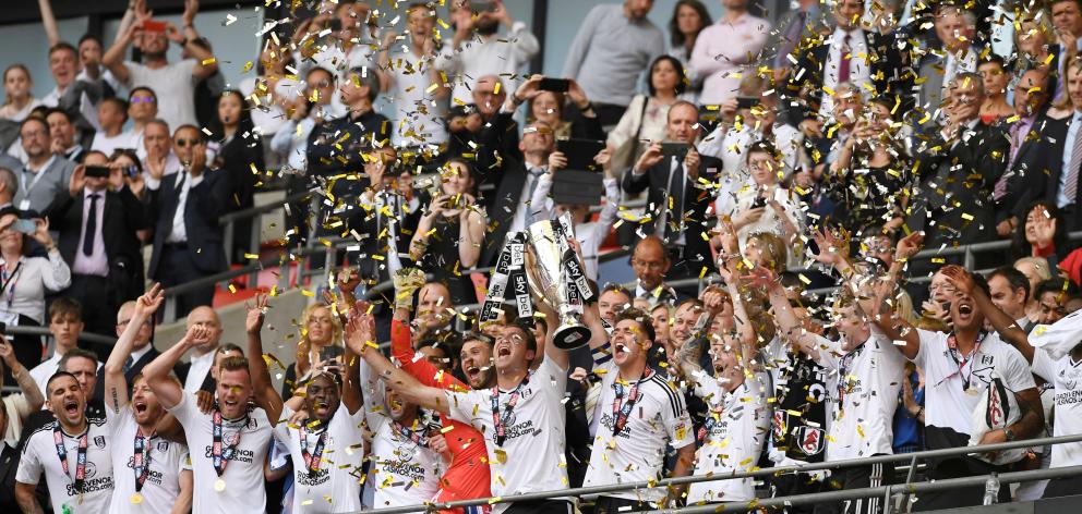 Fulham players and fans celebrate their return to the Premier League. Photo: Reuters