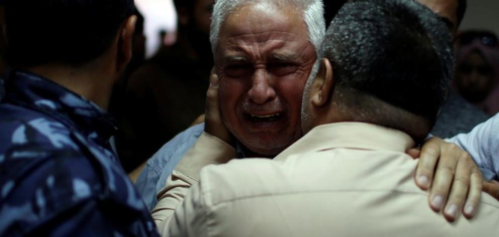 Relative of Palestinian Ahmed al-Rantisi, who was killed during a protest at the Israel-Gaza border, is consoled at a hospital in the northern Gaza Strip. Photo: Reuters/Mohammed Salem