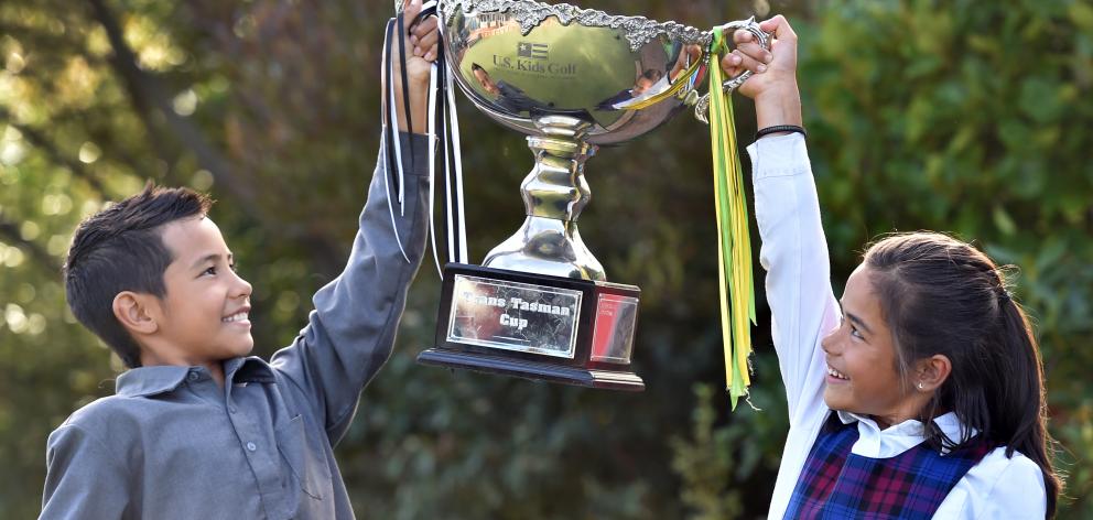 Kairangi (9) and Anahera Koni (8) hold aloft the transtasman trophy they helped win. Photo: Peter McIntosh