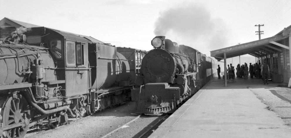 A Dunedin-bound special train stops at Omakau on Easter Tuesday 1961 to pick up passengers,...
