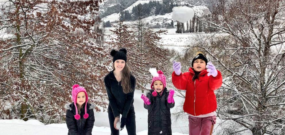 Liz Dotcom plays in the snow with three of Kim’s children at the Dotcoms’ new home near...