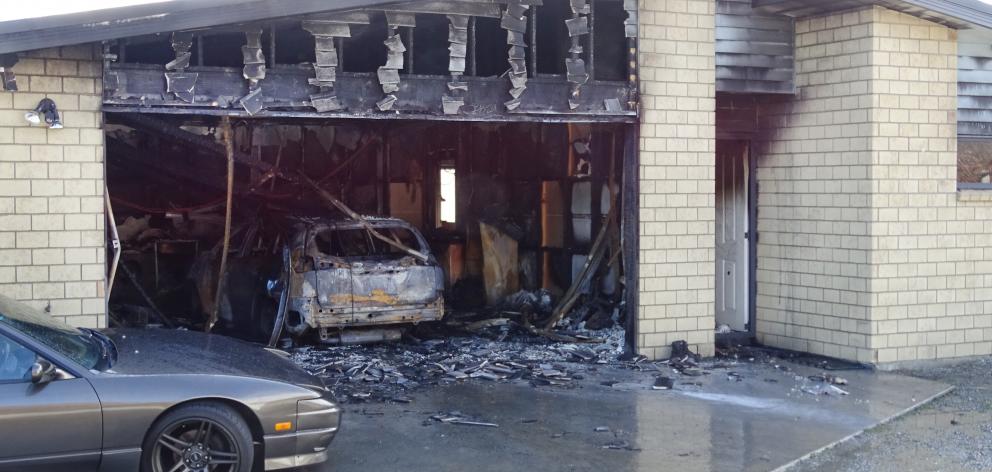 A car, garage and part of a residential property in Lake Hayes Estate, between Arrowtown and Frankton, have significant damage after an early morning fire yesterday. Photo: Tracey Roxburgh