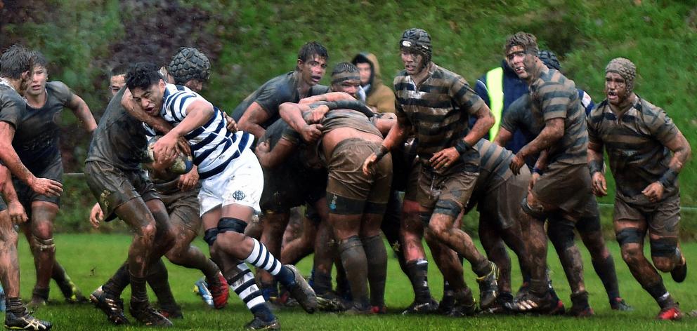 Otago Boys' High School replacement No8 Taniora Raneira (centre) carts the ball up against...