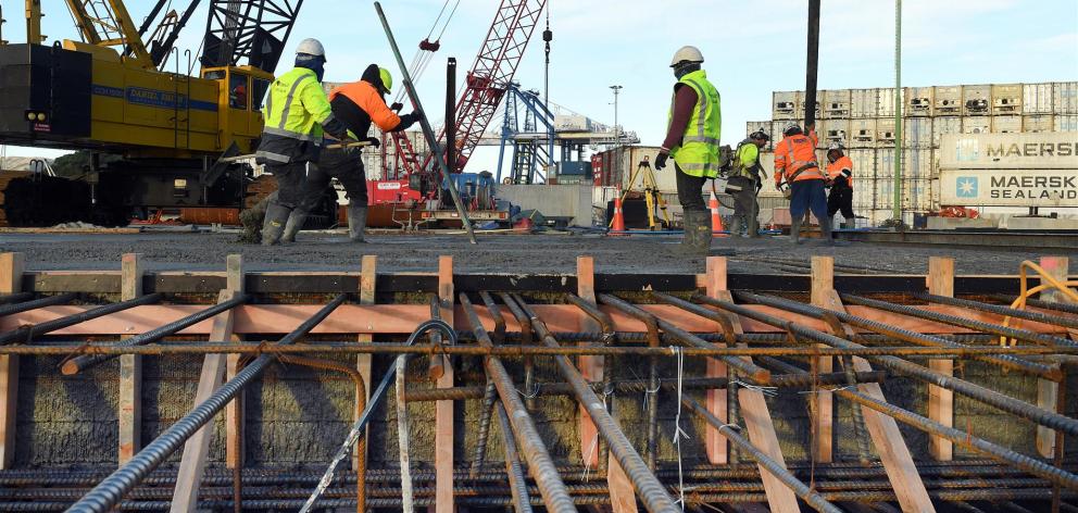Concrete placers and finishers at Port Otago put the finishing touches on the latest wharf concrete pour yesterday. Photo: Stephen Jaquiery