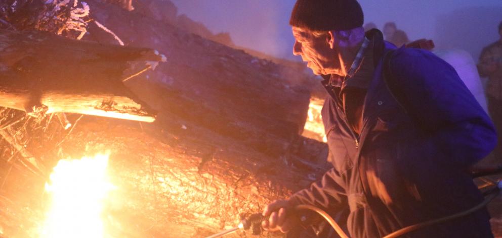 Land owner Ken Gillespie, of Oturehua, lights the Brass Monkey bonfire as he does every year....
